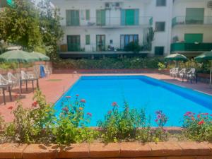 una piscina di fronte a un edificio di Sorrento Home Pool family BIG appartament in Sorrento center a Sorrento