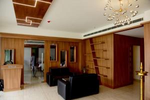 um átrio com uma escada e uma sala de estar em HOTEL EMERALD PALACE em Kottiyam