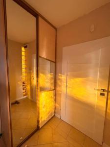 a bathroom with a glass door and a walk in shower at Przestronny apartament in Gdańsk