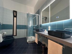 a bathroom with two sinks and a shower at Palazzo Zippitelli Apartments in Bari
