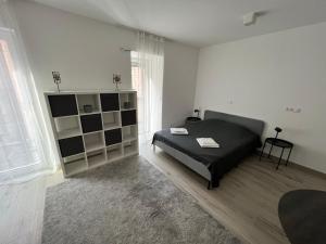 a bedroom with a bed and a book shelf at Bez7 Apartman in Budapest