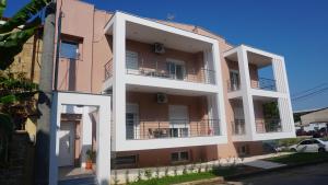 a building with two balconies on the side of it at Feather Apartments-Nea Moudania Halkidiki in Nea Moudania