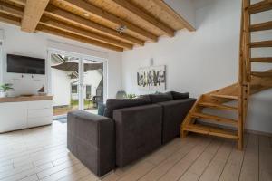 a living room with a couch and a wooden ladder at Ferienhaus Alpaka in Plau am See