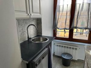 a small kitchen with a sink and a window at Blue vatican house Rome in Rome +34 photos