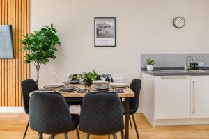 a dining room table and chairs in a kitchen at Premium Apartment - Allocated Parking - Great Location in Plymouth