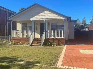 a small house with a porch and a porch at Award winning - Open plan Coastal Beauty in Patonga Beach - Pet Friendly in Patonga