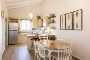 a kitchen with a table and chairs and a refrigerator at Pelagias Villa in Kavros