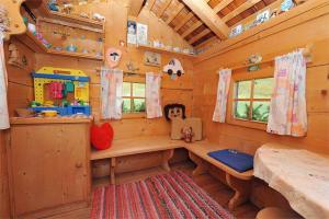 a log cabin room with a bench and windows at Piciulei Pitl in Selva di Val Gardena