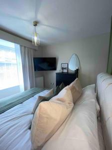 a bedroom with a white bed with pillows on it at Churchview Apartments in Seaham