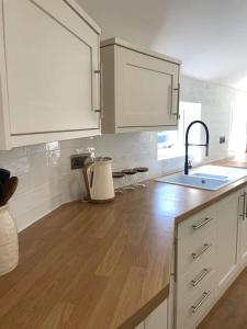 a kitchen with a sink and a wooden counter top at Churchview Apartments in Seaham