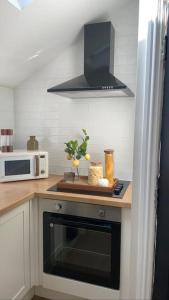 a kitchen with a stove and a microwave at Churchview Apartments in Seaham