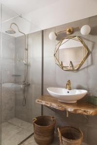 a bathroom with a sink and a mirror at Pelagias Villa in Kavros