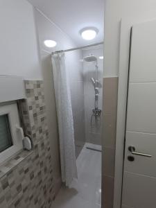 a bathroom with a shower with a shower curtain at Nahorevska vikendica in Sarajevo