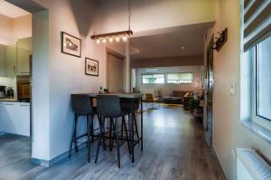 a kitchen and living room with a bar with stools at Emmy's Guesthouse in Sparti