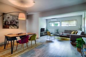 a living room with a table and a couch at Emmy's Guesthouse in Sparti