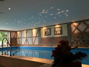 a swimming pool with stars on the ceiling at Hotel AlpenSonne Ruhpolding in Ruhpolding