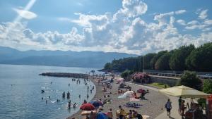 a group of people on a beach in the water at QR Apartment for Family, Couples, and Friends stay in Rijeka in Rijeka
