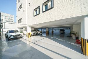 a garage with two cars parked in it at Eumseong Hotel Luem in Eumseong