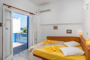 A bed or beds in a room at Apollon Rooms