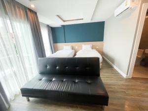 Postel nebo postele na pokoji v ubytování Wisdom Hotel & Residence