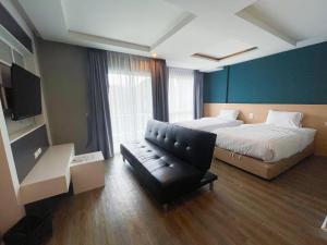 Postel nebo postele na pokoji v ubytování Wisdom Hotel & Residence