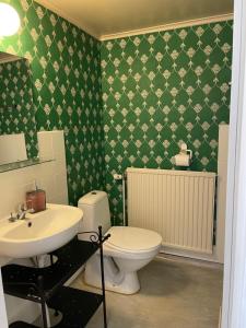 a bathroom with a white toilet and a sink at Patterdale farm holiday apartments in Gamleby