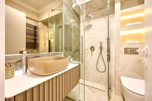 a bathroom with a sink and a shower at Beach Bliss Apartment in Infinity Beach Resort parking in Mamaia