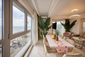 a dining room with a table and views of the ocean at Beach Bliss Apartment in Infinity Beach Resort parking in Mamaia