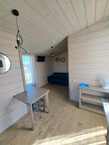 a room with a table and a couch in a room at Ventspils Podnieki in Ventspils