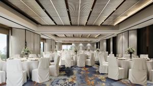 a banquet hall with white tables and white chairs at Grand Copthorne Waterfront in Singapore