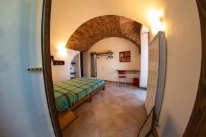 a room with a bed and a hallway with a mirror at Officine Bordighera in Bordighera