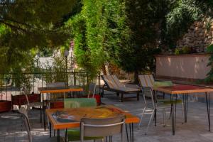 a group of tables and chairs in a patio at Officine Bordighera in Bordighera