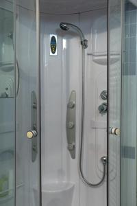 a shower in a bathroom with a glass door at Officine Bordighera in Bordighera