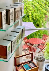 a bunch of boxes on a wall with a table and chairs at Hotell St Clemens in Visby