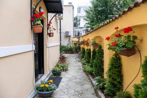 an alley with potted plants on the side of a building at Aristocratic 2bdrm Central Apartment in Varna City