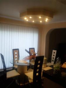 a dining room with a glass table and chairs at Casa Elisei in Asău