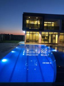 a house with a swimming pool in front of a building at ايله - Aylah 