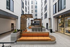 a courtyard in a building with benches and a table at Cosy Ensuites with Shared Kitchen and Living Area at Alma Place in the heart of Belfast in Belfast