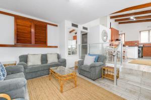 a living room with two couches and a table at San Lameer Villa 1914 - 2 Bedroom Standard - 4 pax - San Lameer Rental Agency in Southbroom