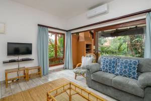 a living room with a couch and a tv at San Lameer Villa 1914 - 2 Bedroom Standard - 4 pax - San Lameer Rental Agency in Southbroom