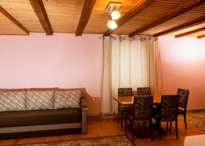 a bedroom with a bed and a table and chairs at Carpathian Comfort in Yaremche