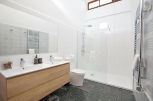 a bathroom with a sink and a toilet and a shower at Villa Palma 2 in Palma de Mallorca