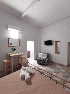 a living room with a couch and a table at Whiteflower Apartments in Bari