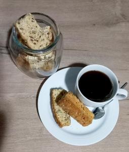 a plate with a piece of bread and a cup of coffee at Lemon Tree Manor - Urban Studio in Groblersdal