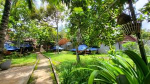 a yard with trees and chairs and a fence at CL Homestay in Sen Monorom