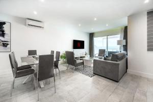 a living room with a table and chairs and a couch at Apartamento Alma in Puerto del Carmen