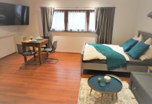 a living room with a bed and a table at Mill Valley Villa in Koblenz