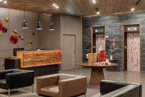 a lobby with chairs and a table in a room at Hotel j-Metropolis in Hsinchu City