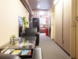 a living room with a couch and a table at HOTEL LiVEMAX BUDGET Nippori in Tokyo