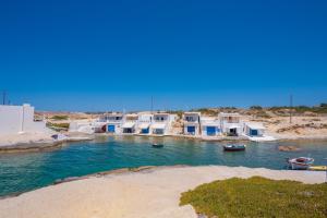 a group of houses and boats in the water at Kanelis Milos Sea Suite in Agia Irini Milos
